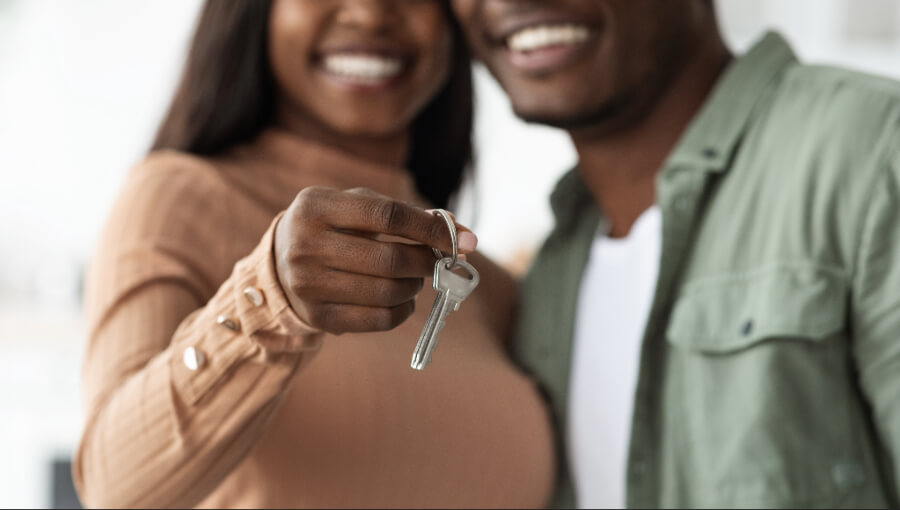 Close-up of hands holding house keys to represent finding a home through the Housing Connect recovery program.